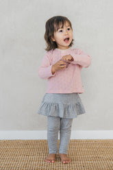 Baby girl wearing Avauma silver misk ruffle skirt leggings with pink heart top – cute and comfortable toddler clothing